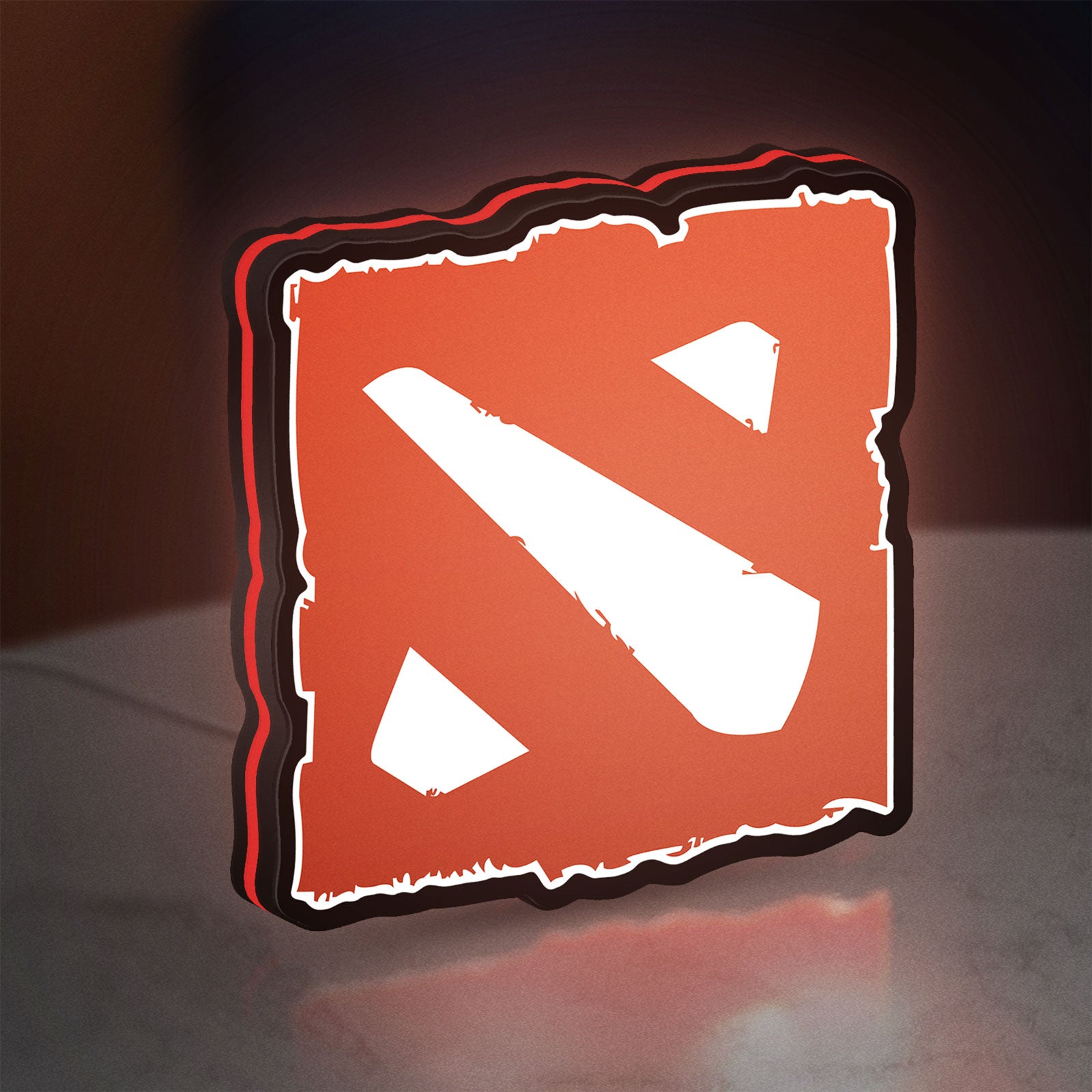 Dota LED lightbox standing on a desk from an angled side view with red glow