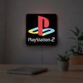 PLAYSTATION 2 LED lightbox hanging on a room wall with soft white light