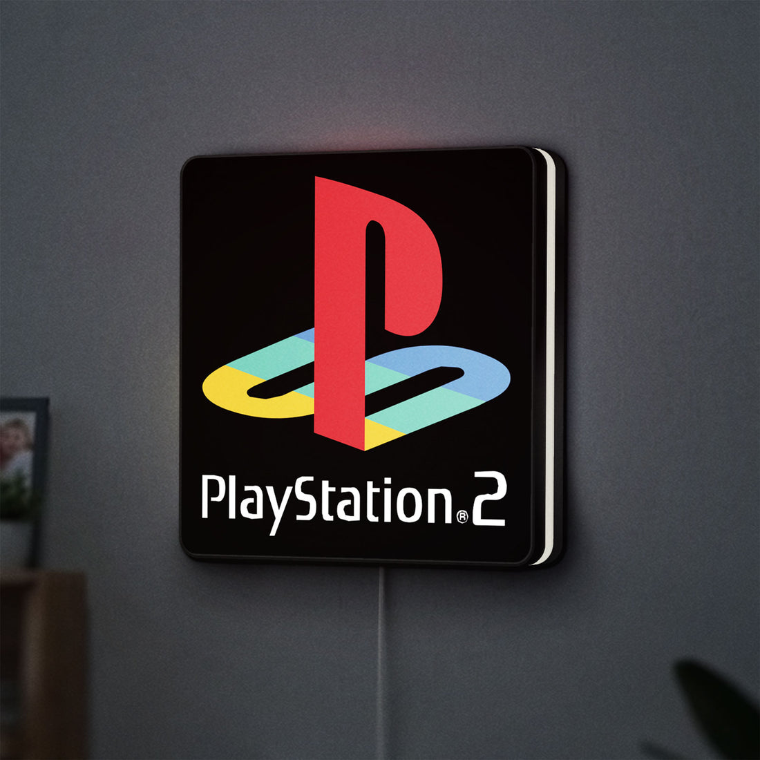 PLAYSTATION 2 LED lightbox hanging on a wall with white glow