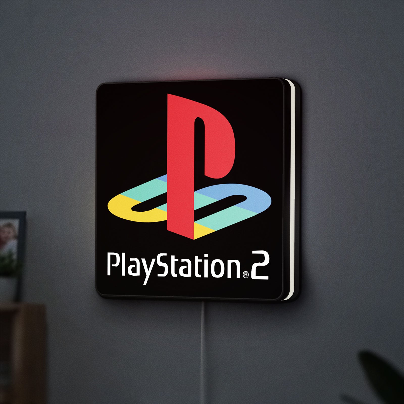 PLAYSTATION 2 LED lightbox hanging on a wall with white glow