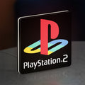 PLAYSTATION 2 LED lightbox standing on a desk from an angled side view with white glow