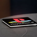 PLAYSTATION 2 LED lightbox lying flat on a desk with white glow