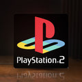 Front view of PLAYSTATION 2 LED lightbox sign glowing on a wooden desk