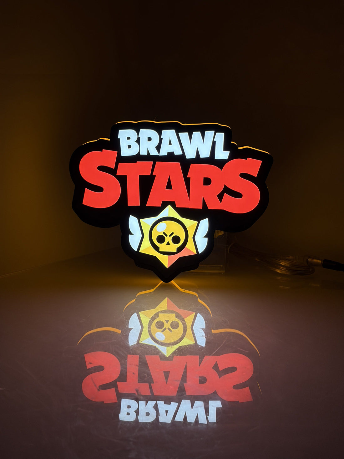 Angled view of the glowing Brawl Stars1 3D LED lightbox, showing its side housing on a tabletop