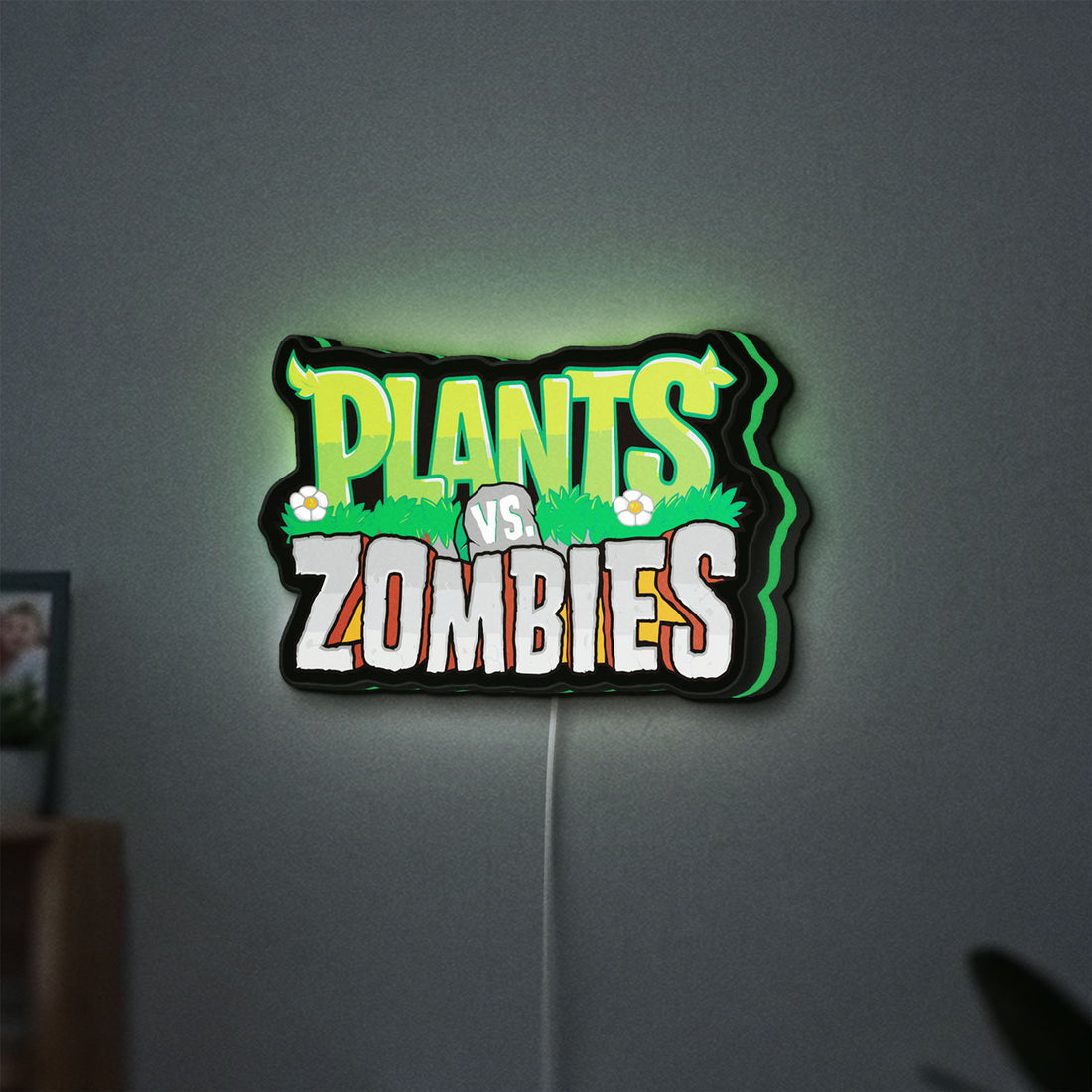 Plants vs Zombies LED lightbox hanging on a wall with green glow