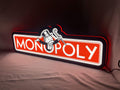 Illuminated angled view standing of Monopoly Money Bag Illuminated Sign in 60cm, unique wall art for desk and room decor