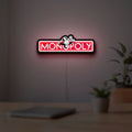 Monopoly Money Bag LED lightbox hanging on a room wall with soft red light