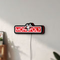 Unlit Monopoly Money Bag LED lightbox mounted on a wall in daylight