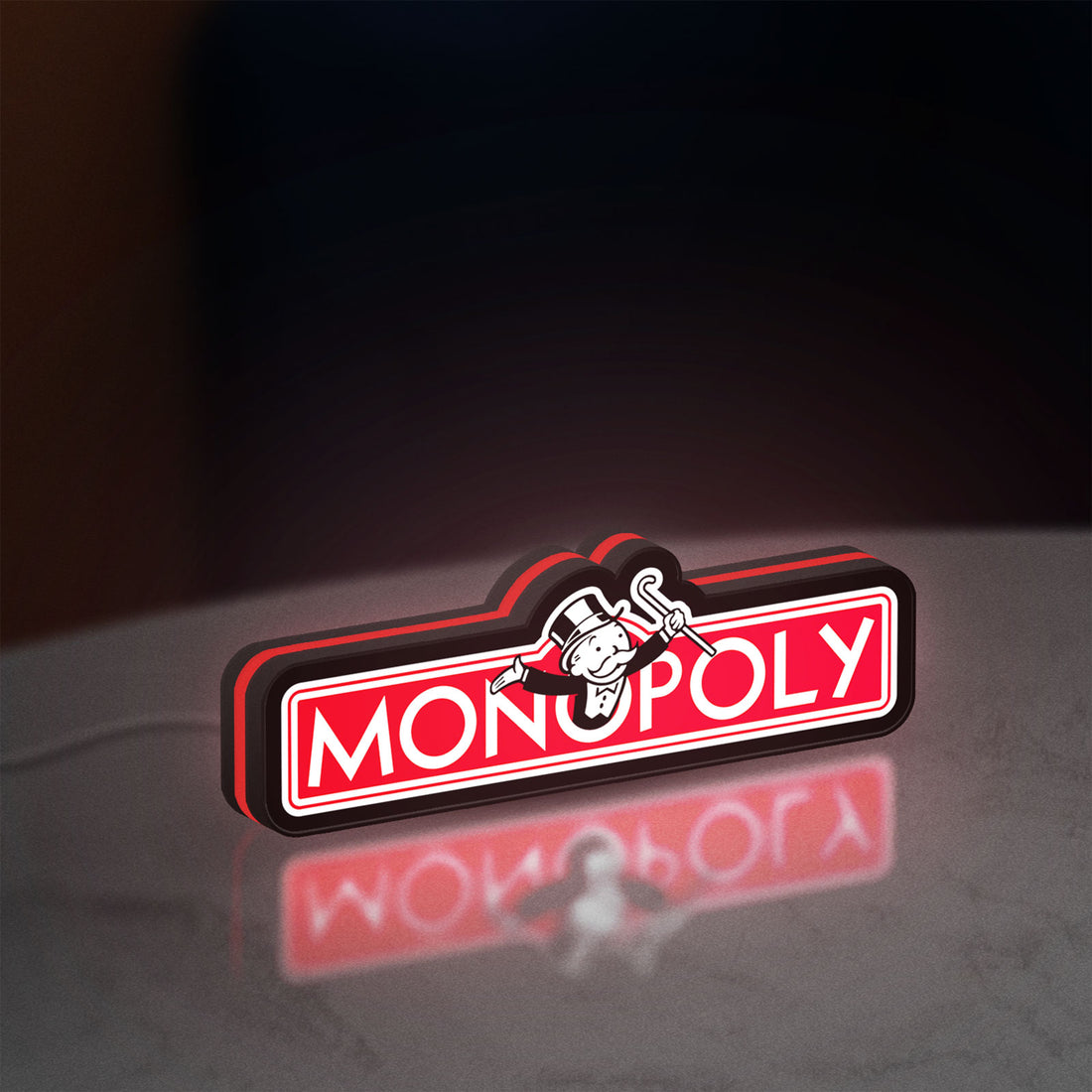 Monopoly Money Bag LED lightbox hanging on a wall with red glow