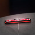 Monopoly Money Bag LED lightbox lying flat on a desk with red glow
