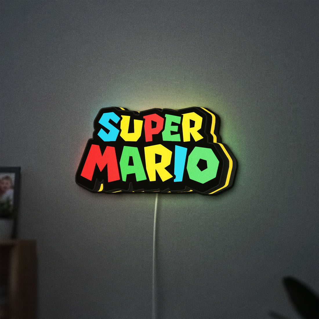 Super Mario LED lightbox hanging on a wall with yellow glow