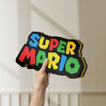Unlit Super Mario LED lightbox held by hand to show size and details