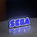 Sega LED lightbox standing on a desk from an angled side view with blue glow