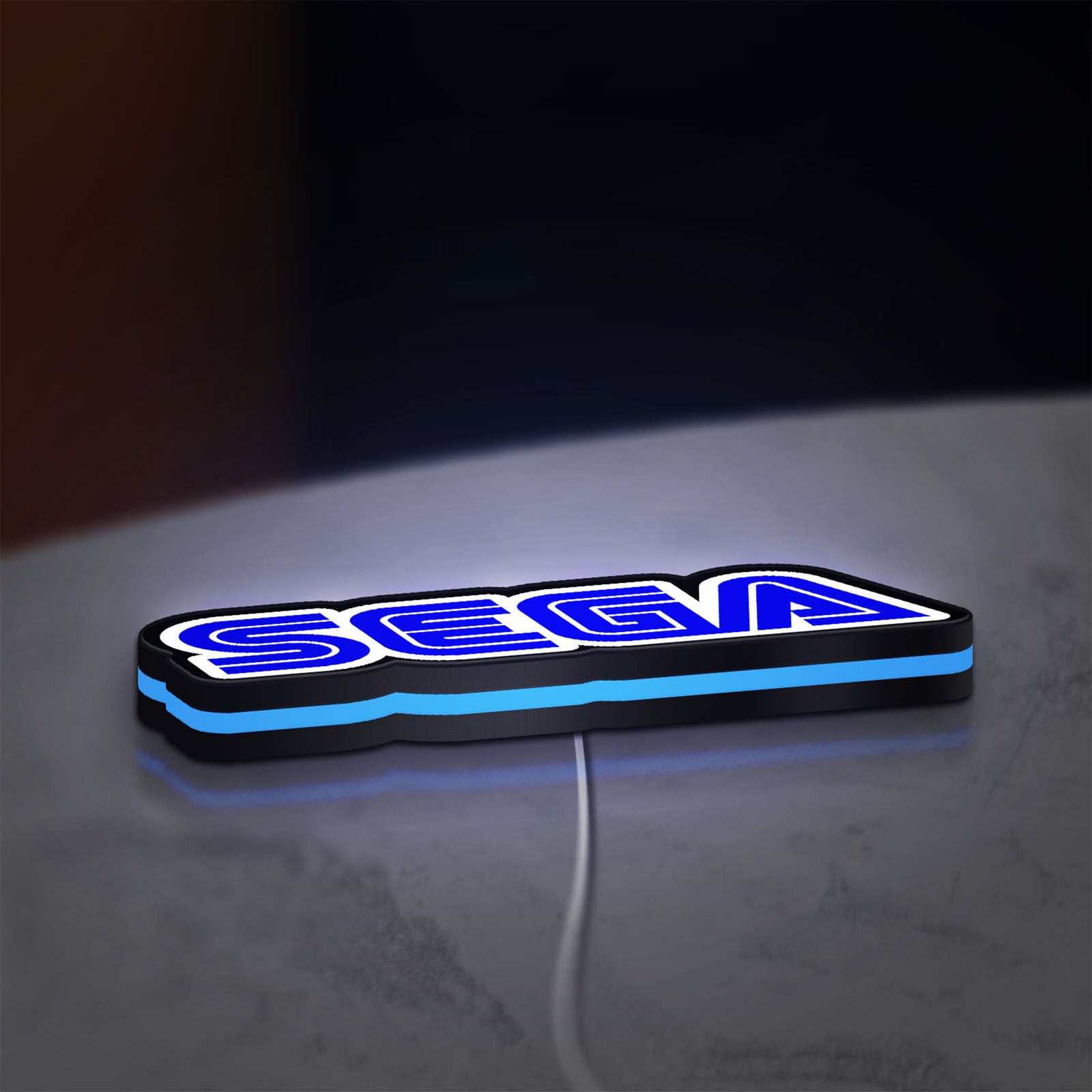Sega LED lightbox lying flat on a desk with blue glow