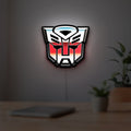 Transformers Autobots LED lightbox hanging on a room wall with soft white light