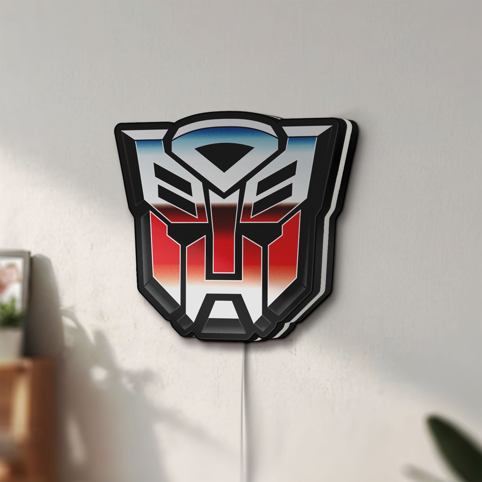 Unlit Transformers Autobots LED lightbox mounted on a wall in daylight