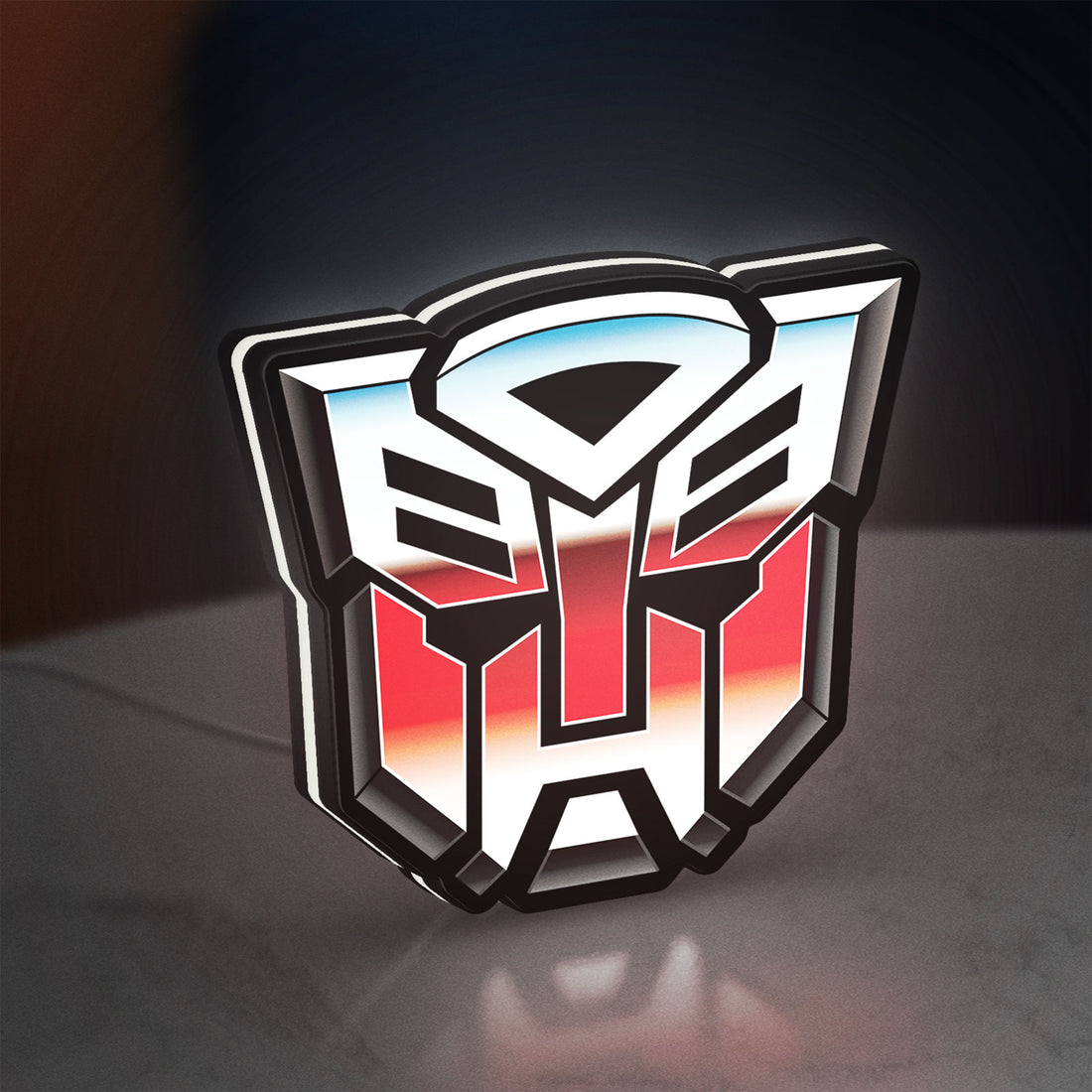 Transformers Autobots LED lightbox hanging on a wall with white glow