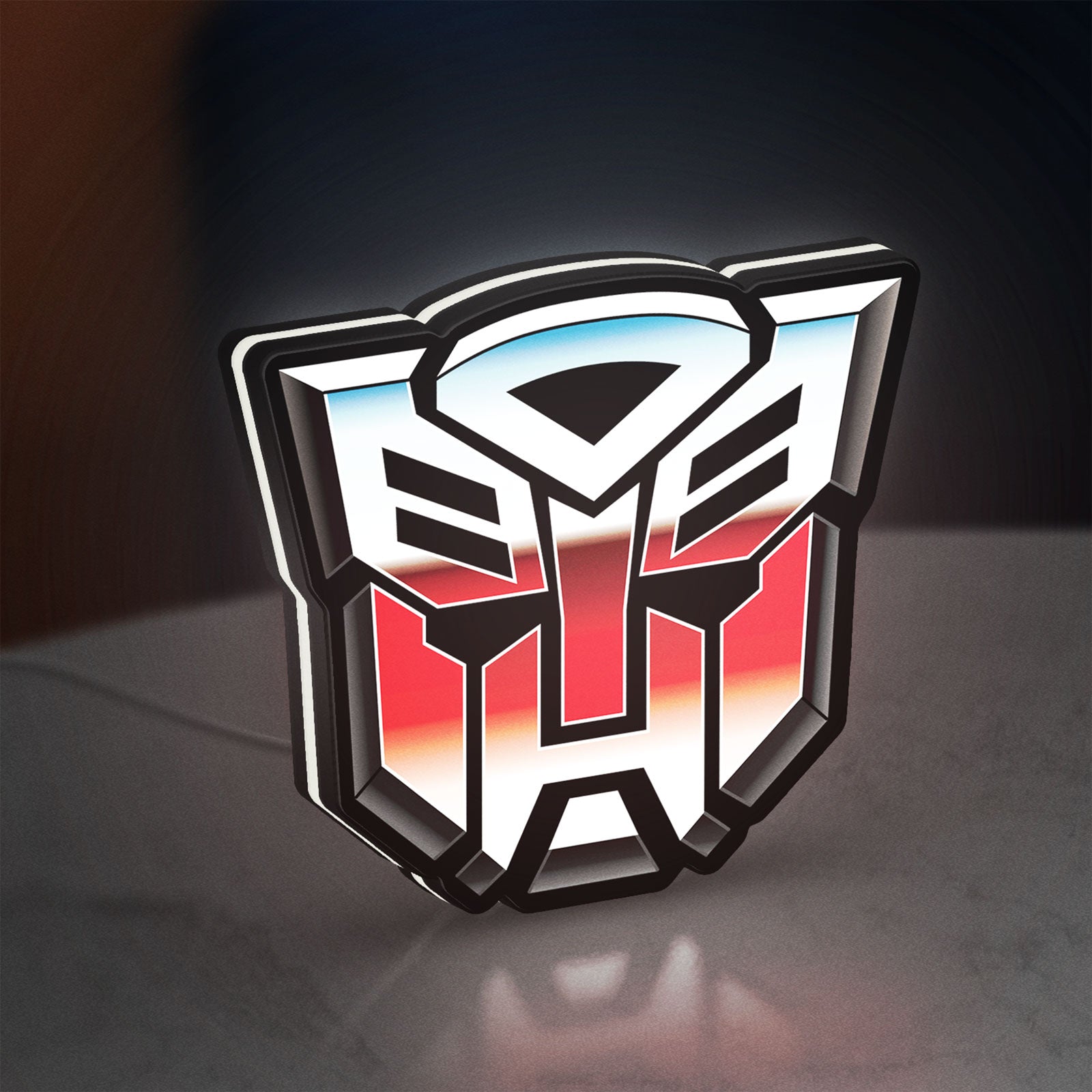 Transformers Autobots LED lightbox standing on a desk from an angled side view with white glow