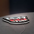 Transformers Autobots LED lightbox lying flat on a desk with white glow