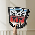 Unlit Transformers Autobots LED lightbox held by hand to show size and details