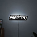 Need for Speed Prostreet Sign LED lightbox hanging on a wall with white glow