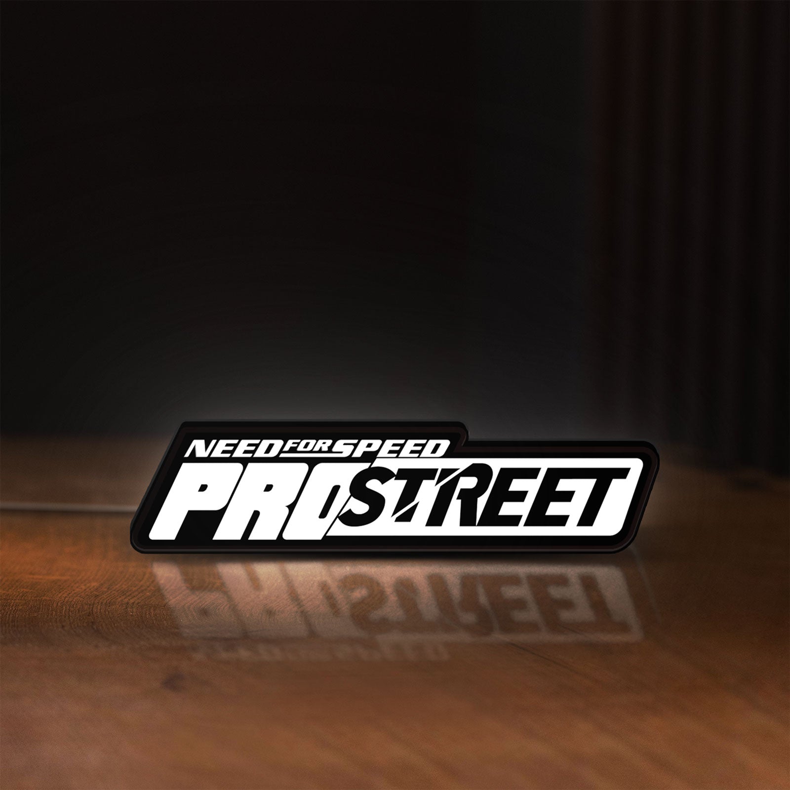 Front view of Need for Speed Prostreet Sign LED lightbox sign glowing on a wooden desk