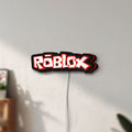 Unlit Roblox LED lightbox mounted on a wall in daylight