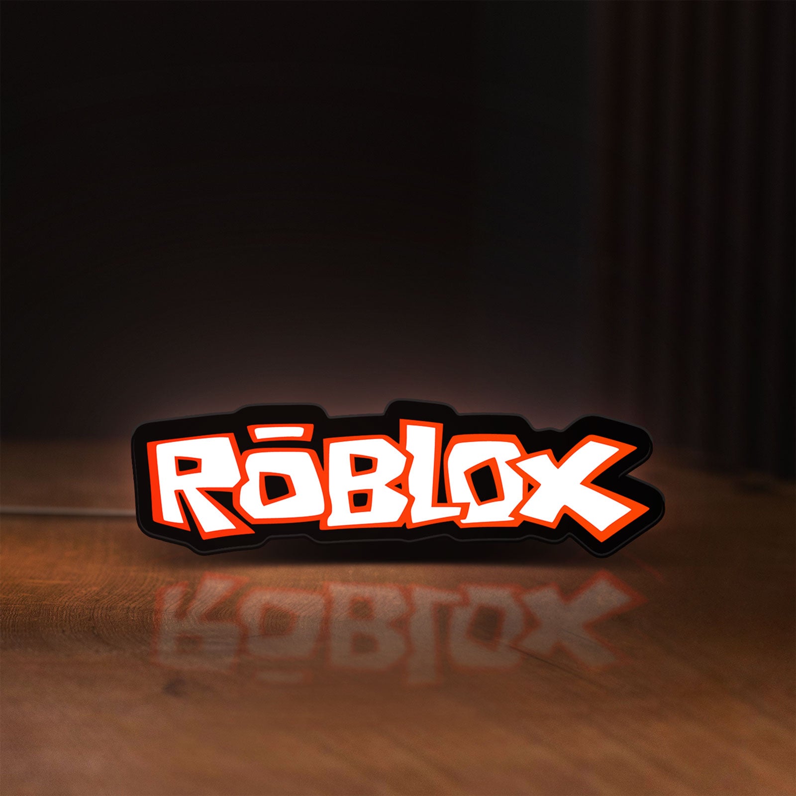 Front view of Roblox LED lightbox sign glowing on a wooden desk