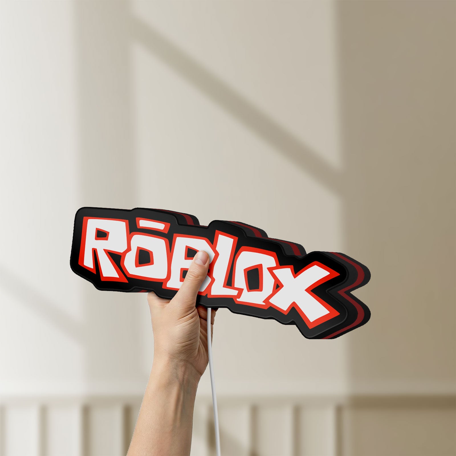 Unlit Roblox LED lightbox held by hand to show size and details