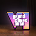Front view of GTA VI LED lightbox sign glowing on a wooden desk