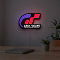 Gran Turismo LED lightbox hanging on a room wall with soft white light