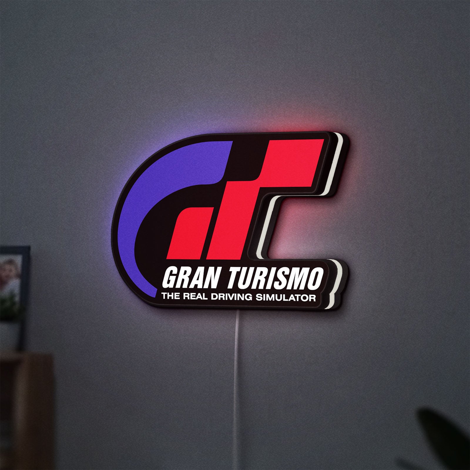 Gran Turismo LED lightbox hanging on a wall with white glow