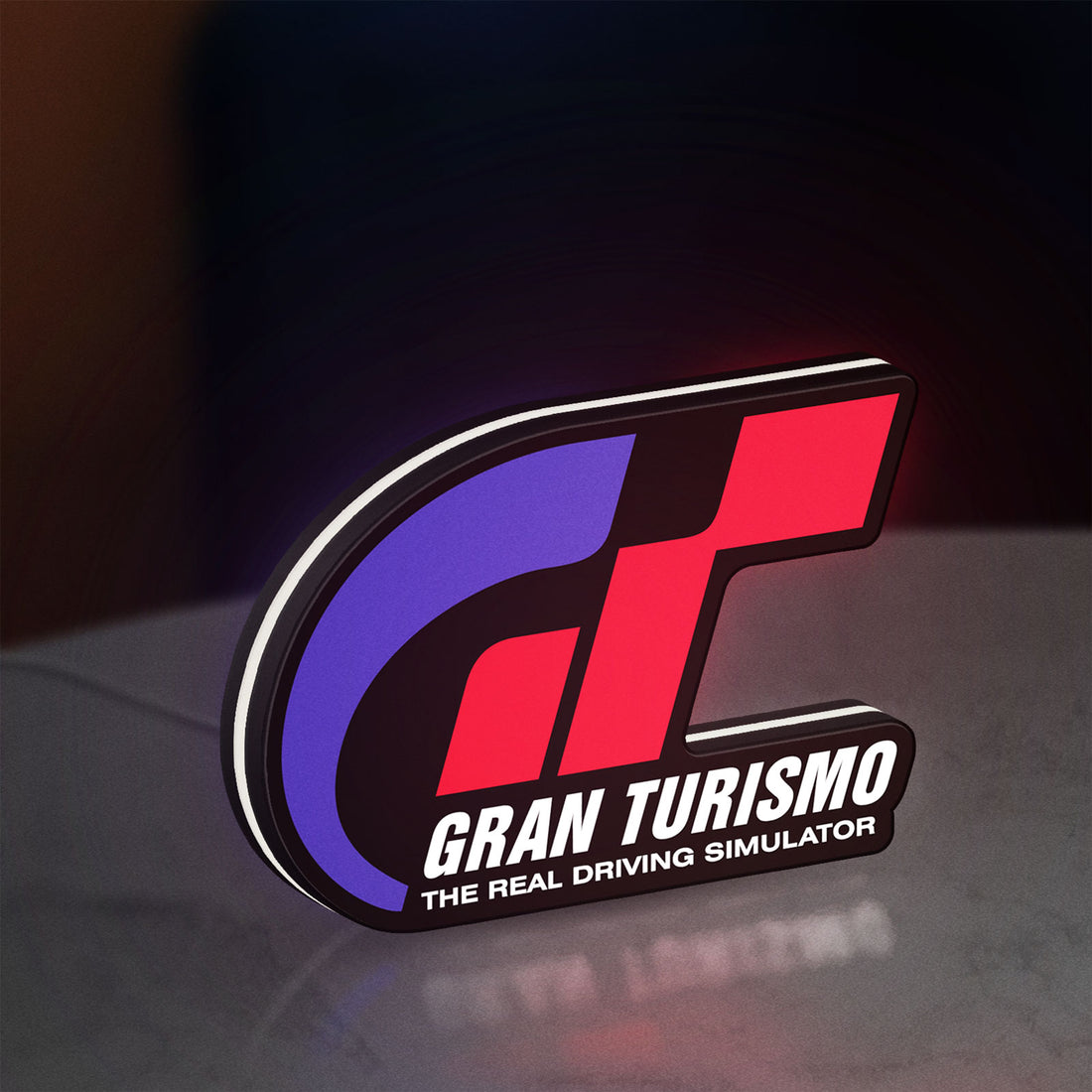 Gran Turismo LED lightbox hanging on a wall with white glow