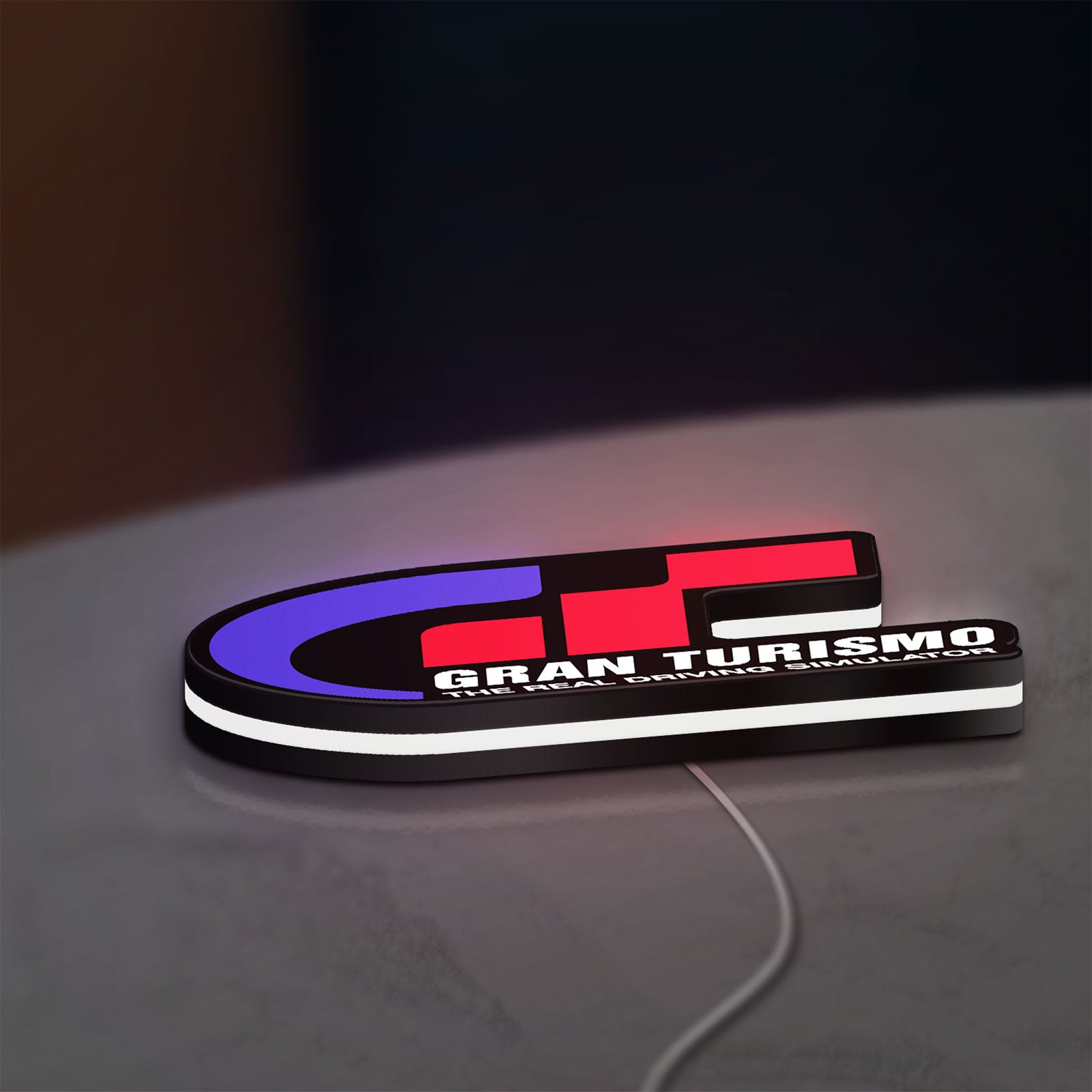 Gran Turismo LED lightbox lying flat on a desk with white glow