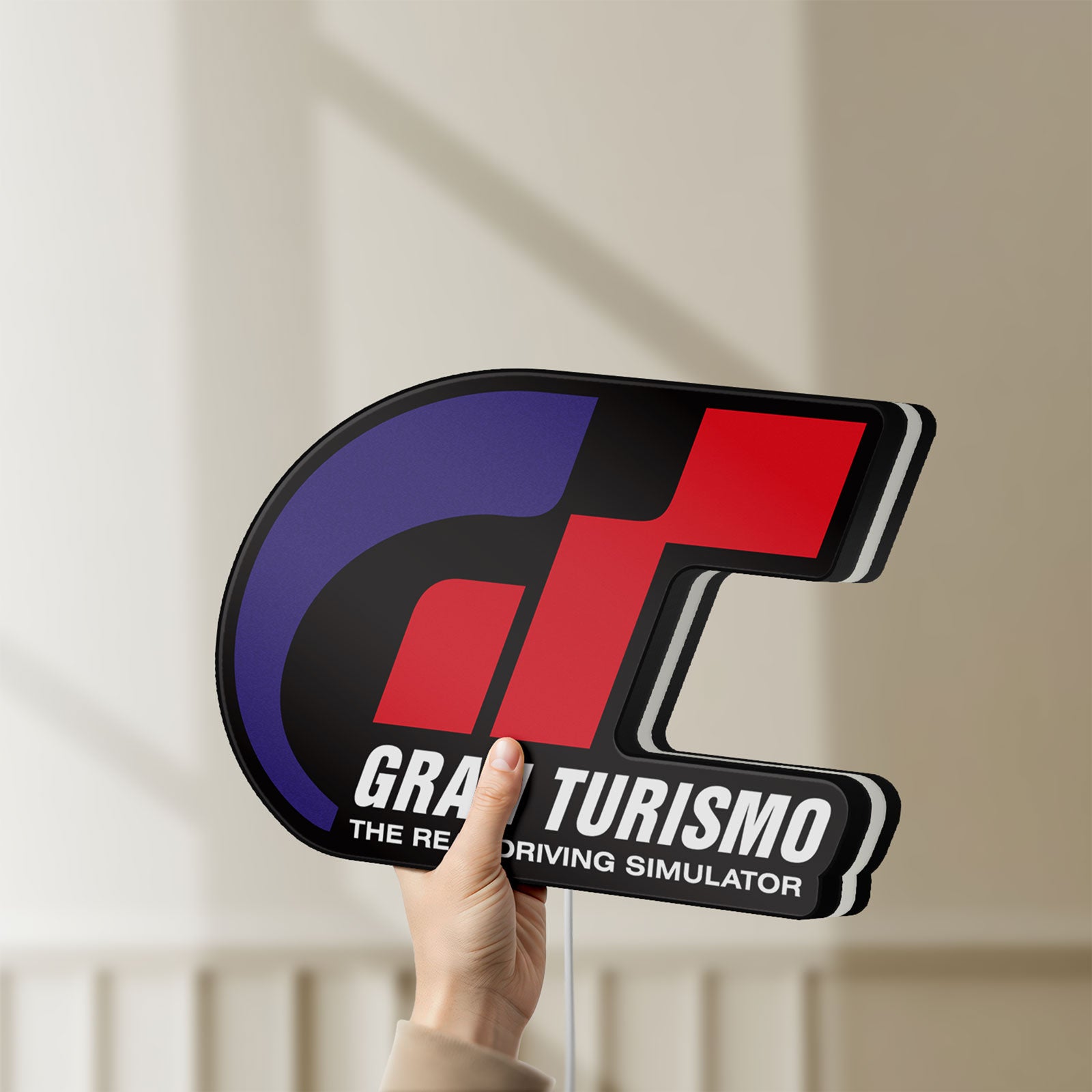 Unlit Gran Turismo LED lightbox held by hand to show size and details