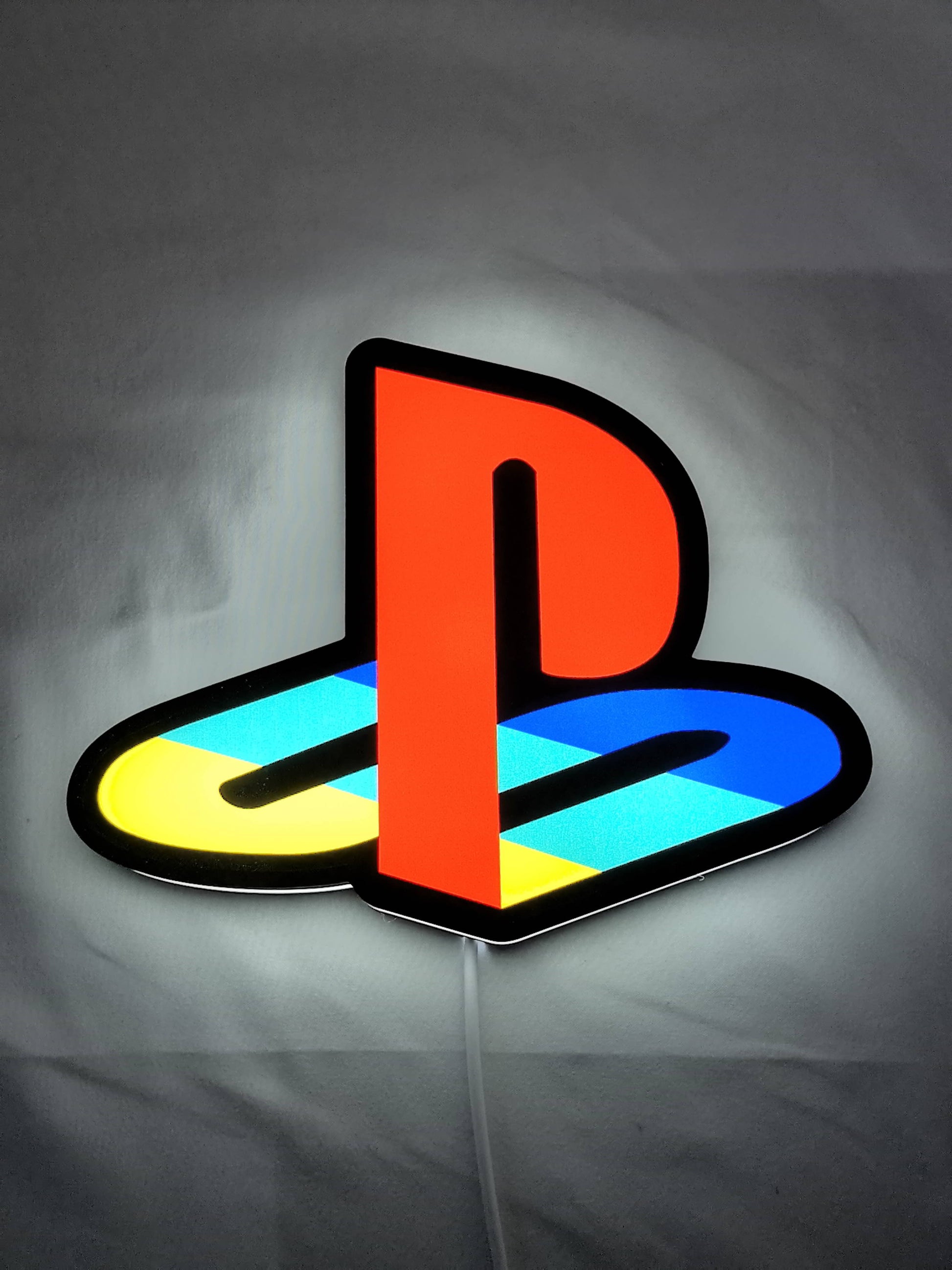 Illuminated flat lay front view of Playstation 3D LED Sign in 20cm, unique wall art for desk and room decor