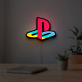 Playstation LED lightbox hanging on a room wall with soft white light