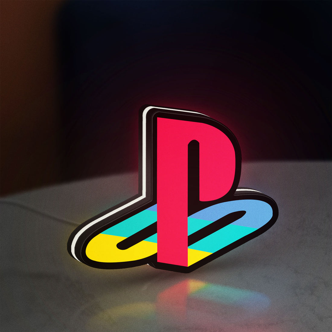 Playstation LED lightbox hanging on a wall with white glow