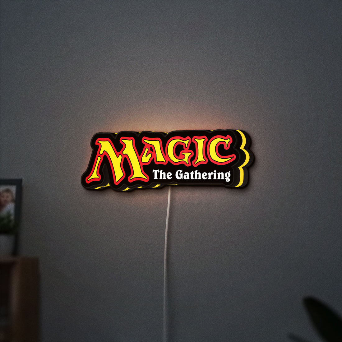 Magic The Gathering LED lightbox hanging on a wall with yellow glow