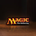 Front view of Magic The Gathering LED lightbox sign glowing on a wooden desk