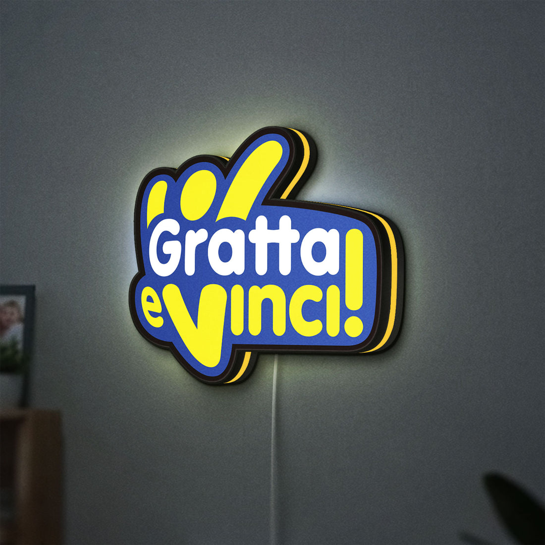 Gratta e Vinci LED lightbox hanging on a wall with yellow glow