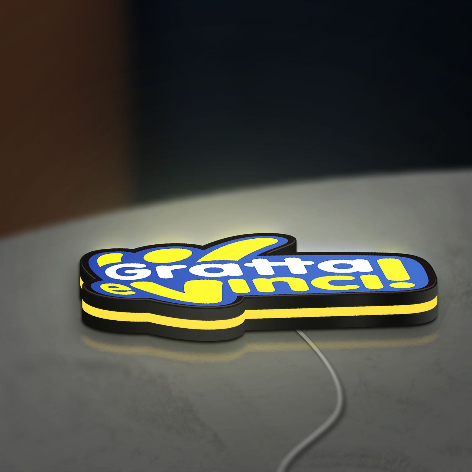 Gratta e Vinci LED lightbox lying flat on a desk with yellow glow