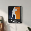 Unlit CSGO LED lightbox mounted on a wall in daylight