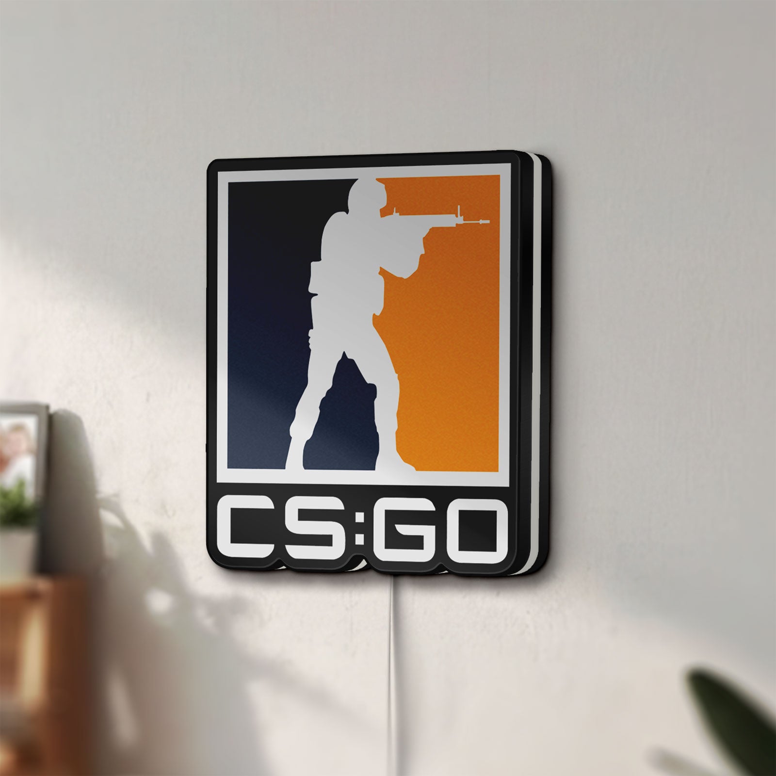 Unlit CSGO LED lightbox mounted on a wall in daylight