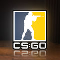 Front view of CSGO LED lightbox sign glowing on a wooden desk