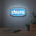 Chicco LED lightbox hanging on a room wall with soft blue light