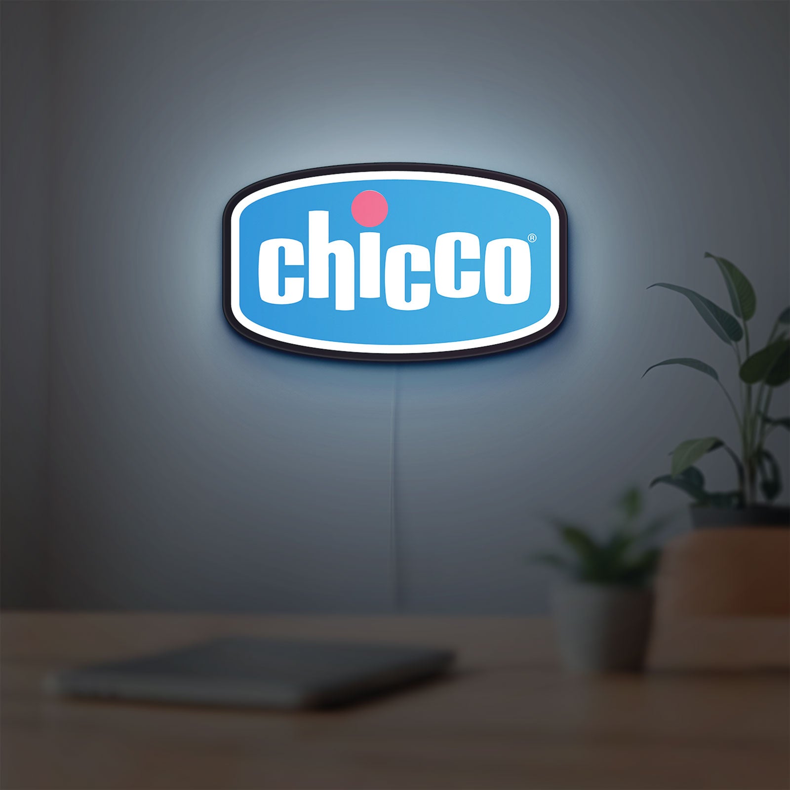 Chicco LED lightbox hanging on a room wall with soft blue light