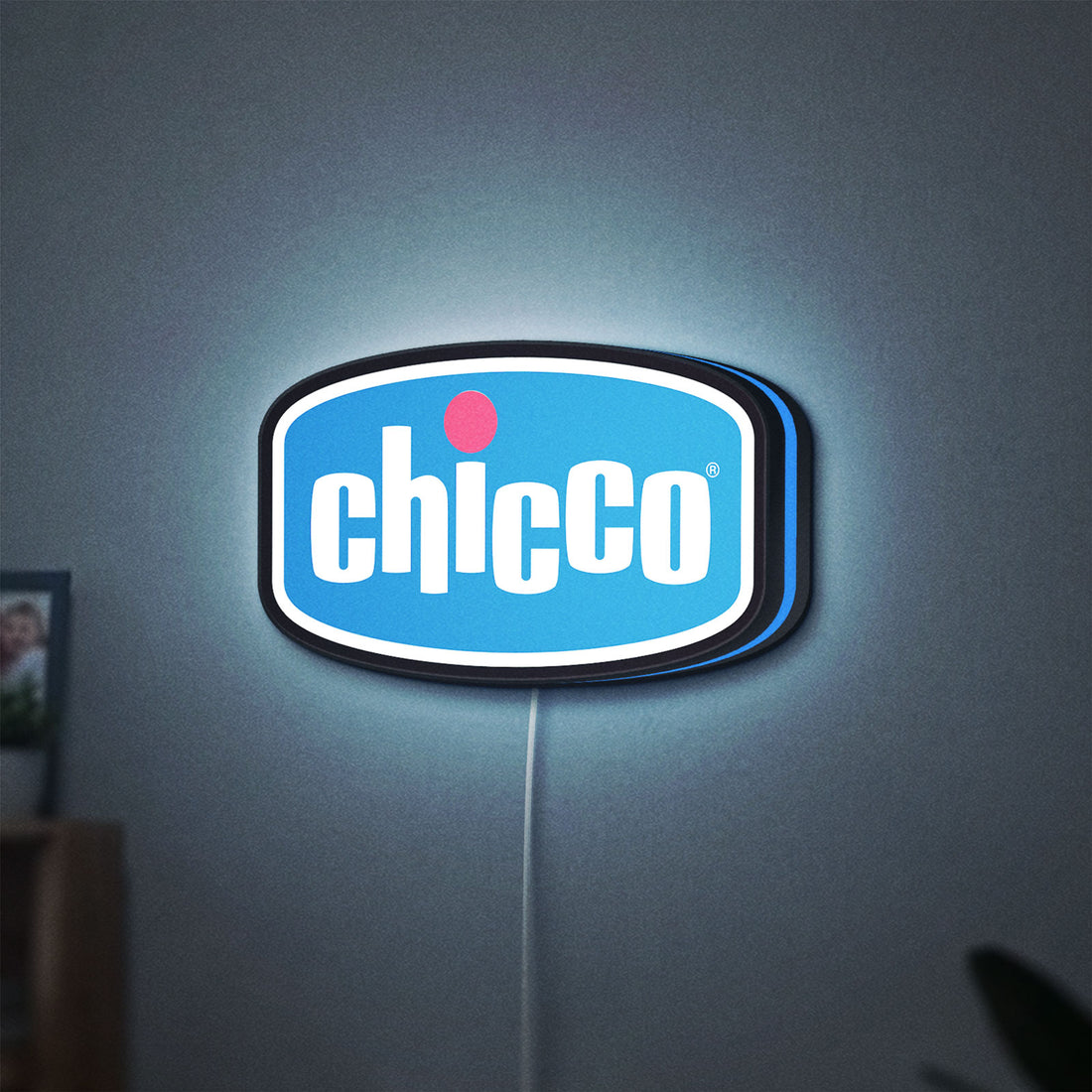 Chicco LED lightbox hanging on a wall with blue glow