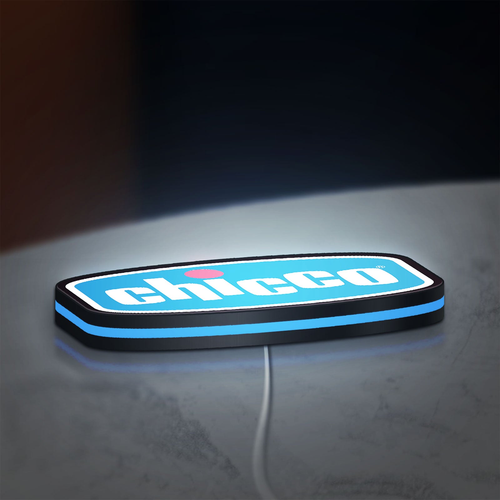 Chicco LED lightbox lying flat on a desk with blue glow