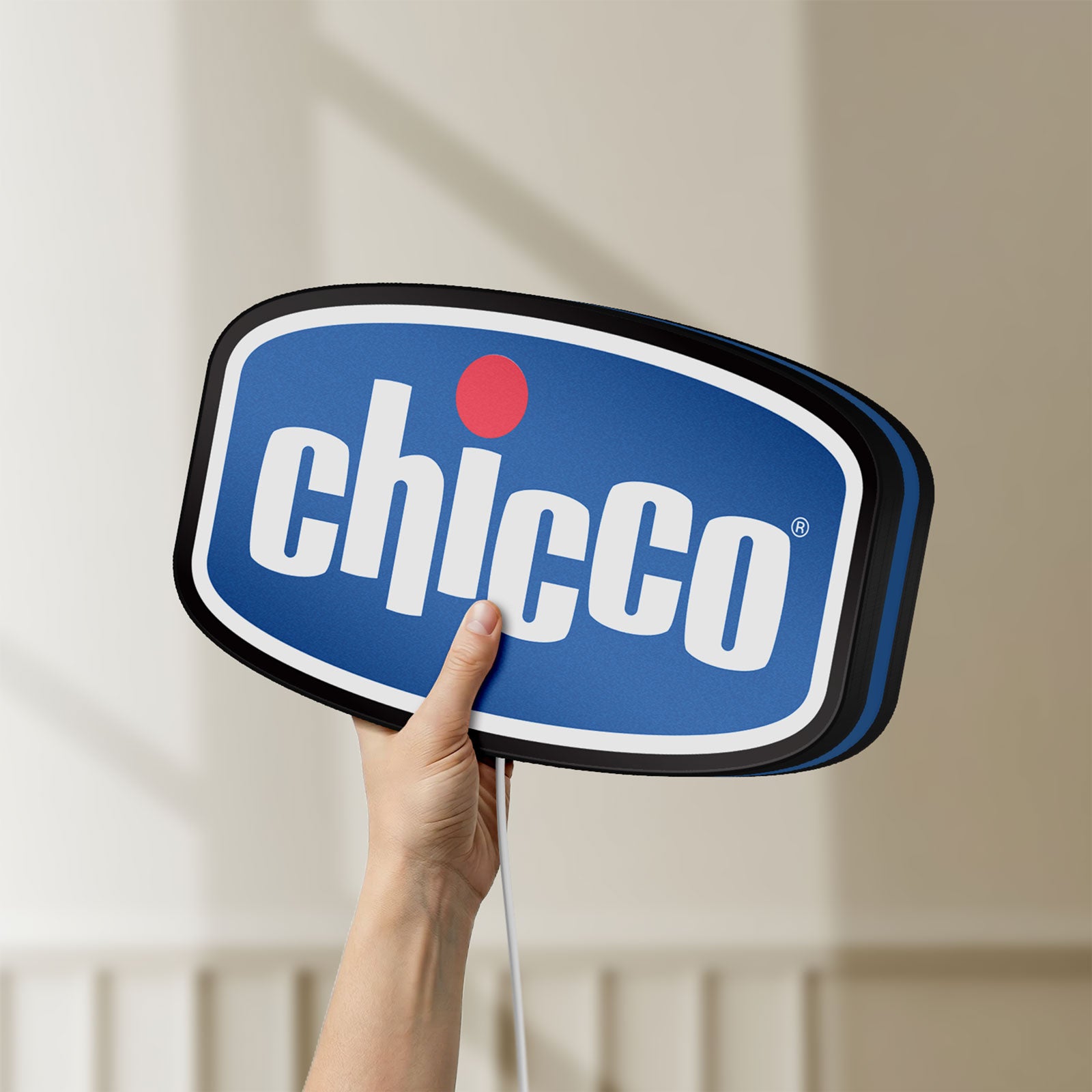 Unlit Chicco LED lightbox held by hand to show size and details
